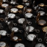 An exquisite display of various vintage pocket watches with intricate designs and metallic finishes.
