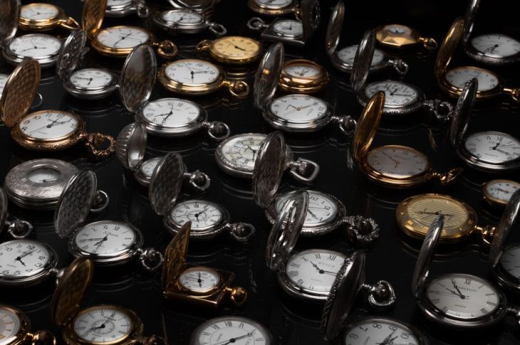 An exquisite display of various vintage pocket watches with intricate designs and metallic finishes.