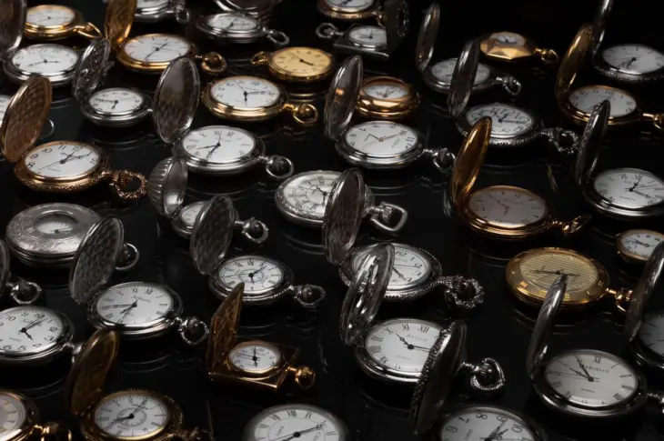 An exquisite display of various vintage pocket watches with intricate designs and metallic finishes.