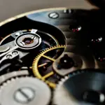 a close up of a watch face with the gears missing