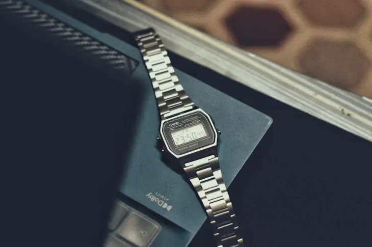 a watch sitting on top of a book on a table