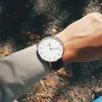 person wearing round silver-colored analog watch at 1:19