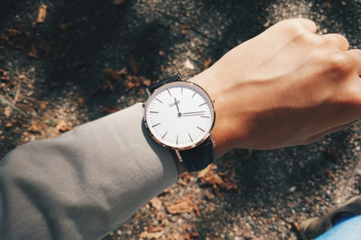 person wearing round silver-colored analog watch at 1:19